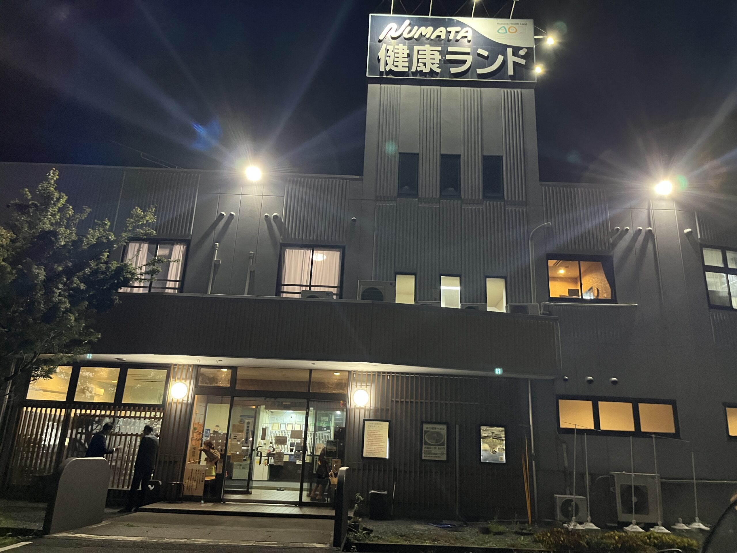 夜の沼田健康ランドの建物と入口